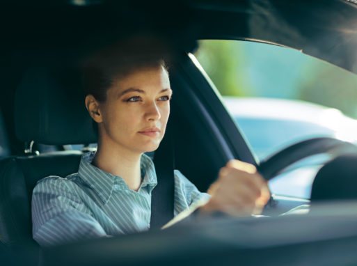 Close up of a businesswoman driving a car